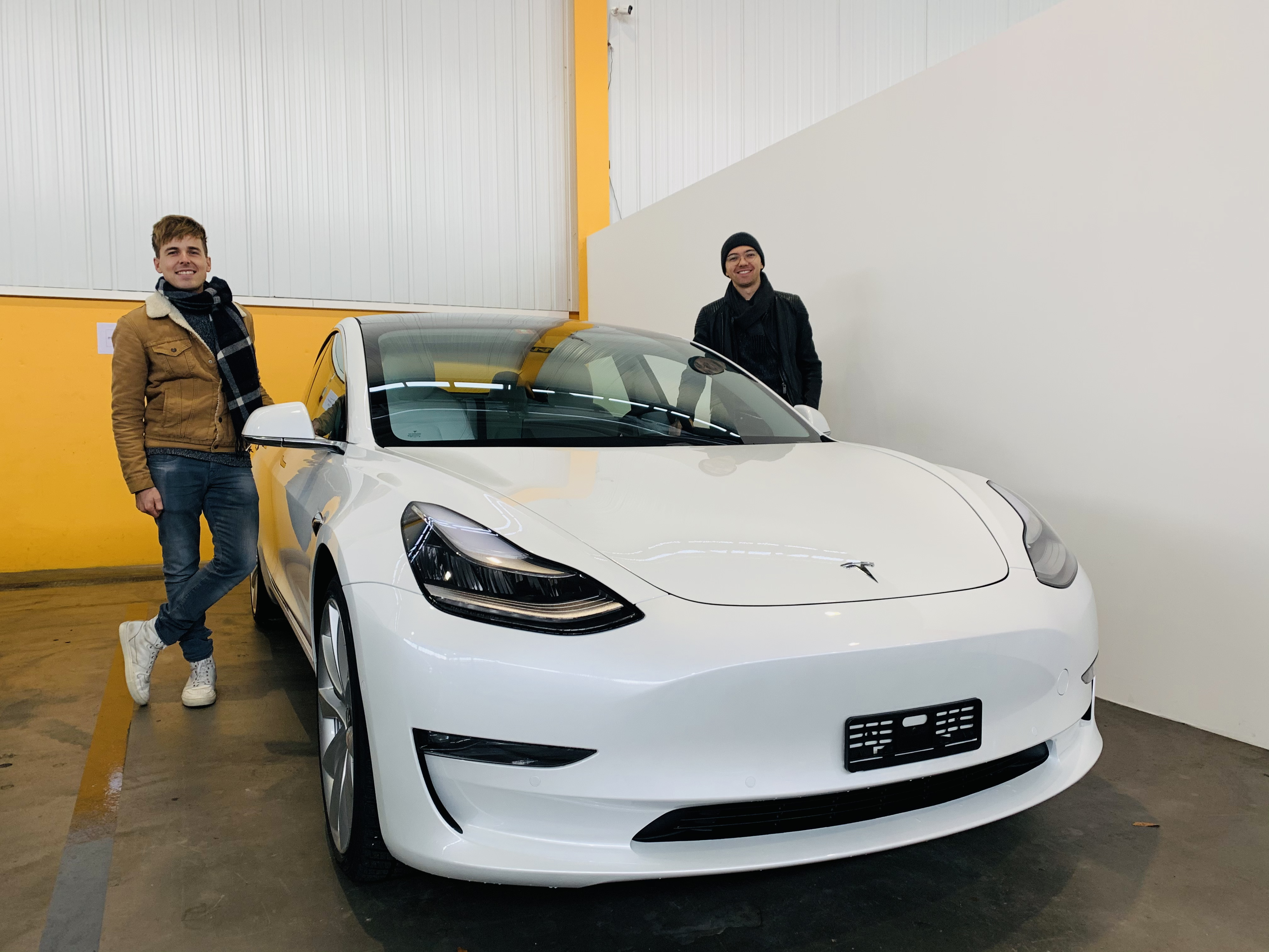 Lorenz (left) and Jip (right) next to their new Tesla Model 3 Performance on the day of pick-up at Tesla Zürich.