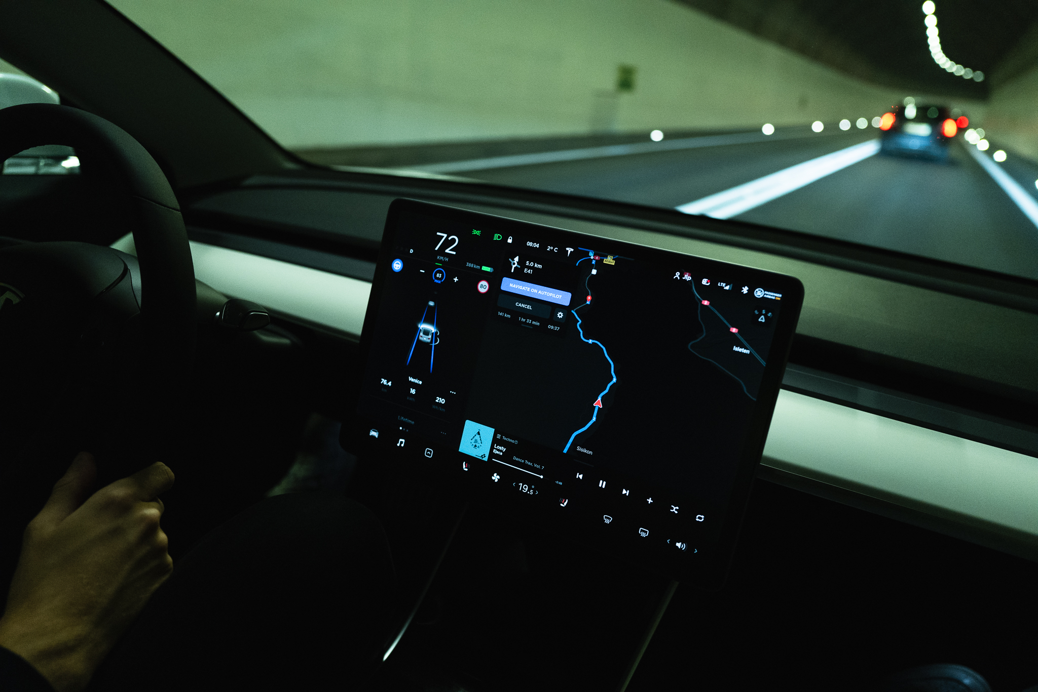 Driving through the Gotthard tunnel with auto pilot visible on the Tesla display.