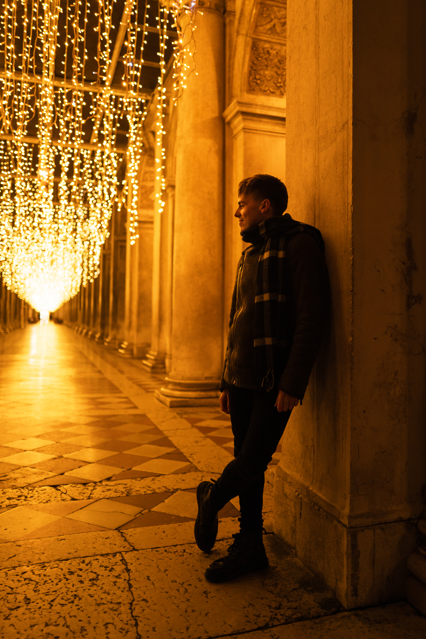 Portrait in front of the San Marco galleries, decorated with Christmas lights.